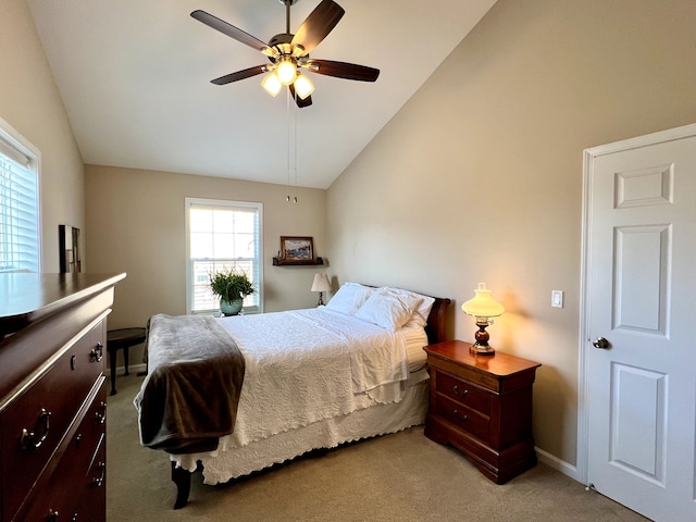 bedroom with a ceiling fan, lofted ceiling, light colored carpet, and baseboards