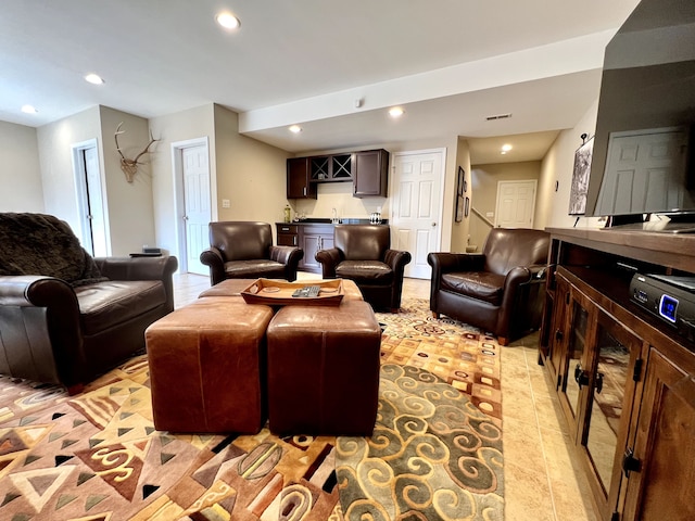 living room with recessed lighting, indoor wet bar, visible vents, and light tile patterned floors