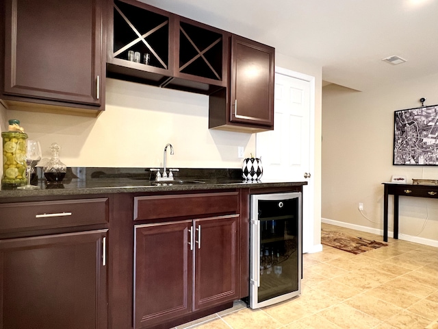 bar featuring visible vents, baseboards, wine cooler, indoor wet bar, and a sink