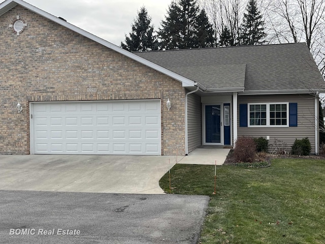 view of front of house with a front lawn, concrete driveway, a shingled roof, a garage, and brick siding