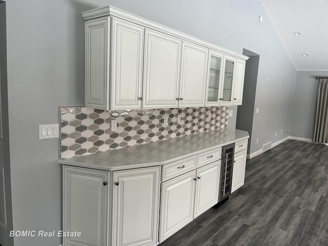 kitchen with beverage cooler, tasteful backsplash, light countertops, and vaulted ceiling