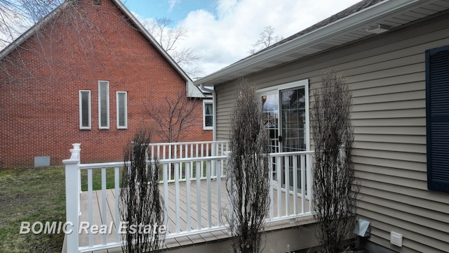 view of side of home with a deck