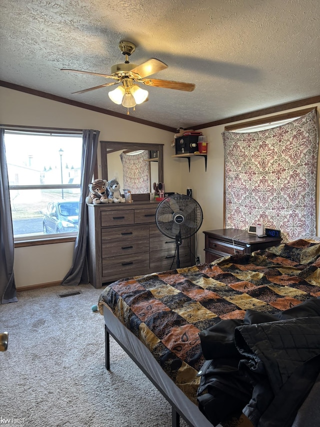 carpeted bedroom with ornamental molding, a textured ceiling, and ceiling fan