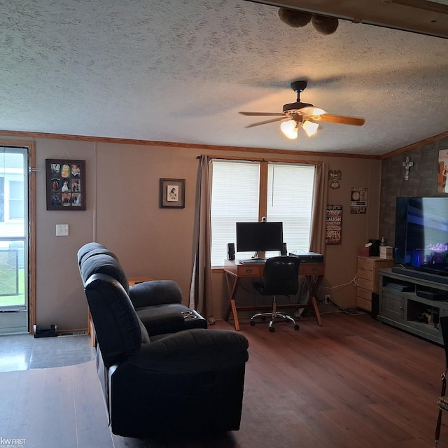office space featuring wood finished floors, a ceiling fan, crown molding, and a textured ceiling