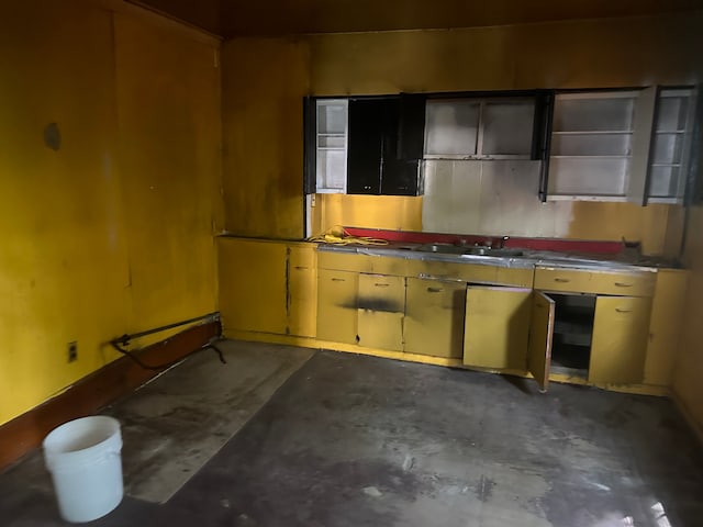 kitchen with concrete flooring and a sink