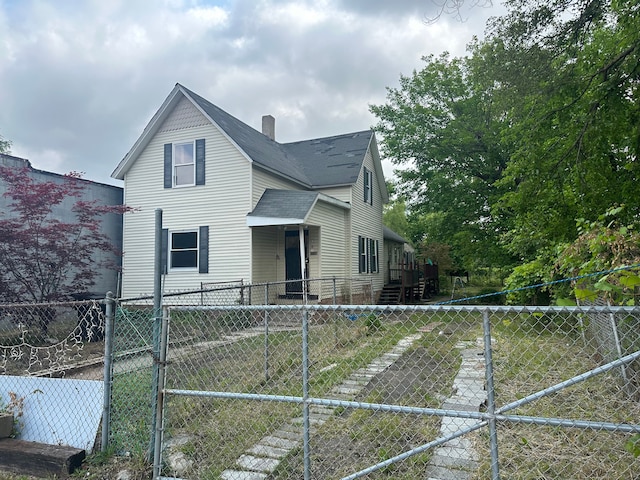 exterior space featuring a shingled roof, a chimney, and fence