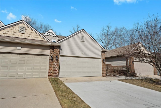 view of front facade with brick siding, concrete driveway, and a garage