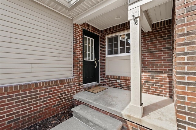 property entrance with brick siding