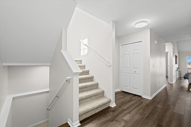 stairs featuring wood finished floors and baseboards