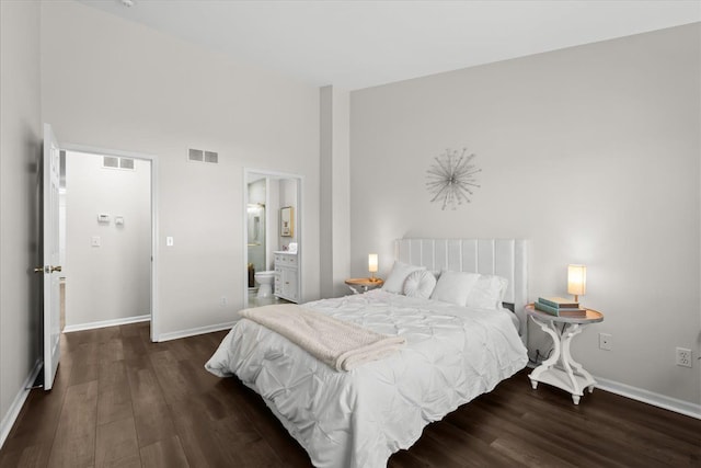 bedroom with visible vents, baseboards, and wood finished floors