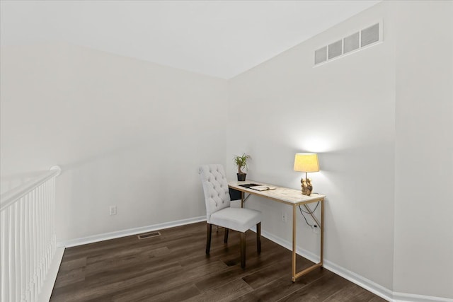 office space with wood finished floors, visible vents, and baseboards