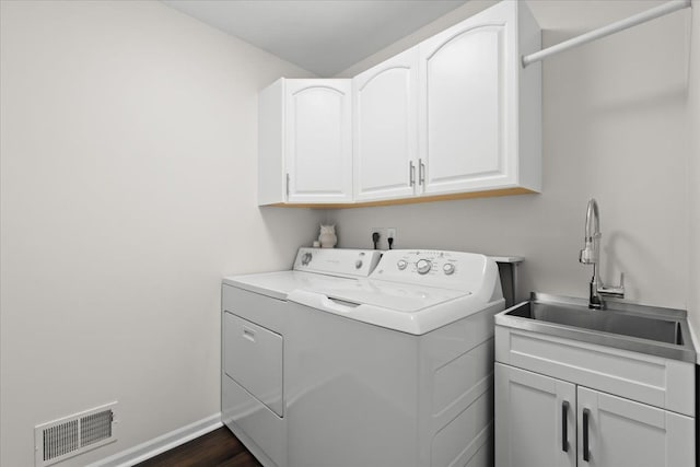 laundry room featuring baseboards, visible vents, cabinet space, a sink, and washing machine and dryer