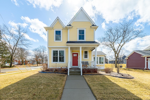 view of front of house with covered porch and a front lawn