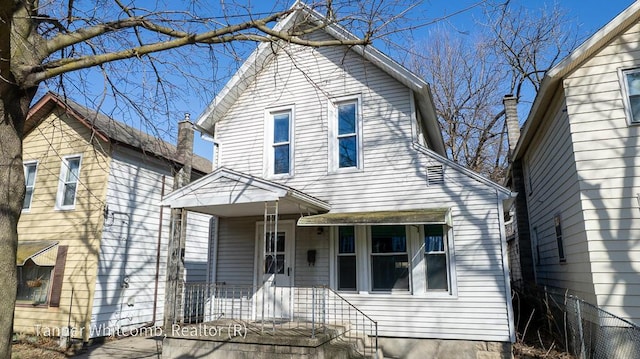 view of front of house featuring covered porch and fence