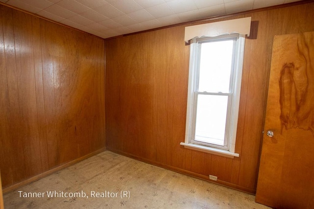 spare room with wooden walls