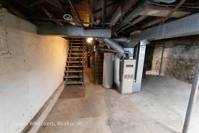 unfinished basement featuring gas water heater and heating unit