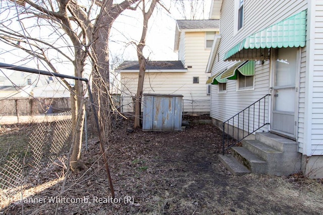 view of yard with entry steps and fence