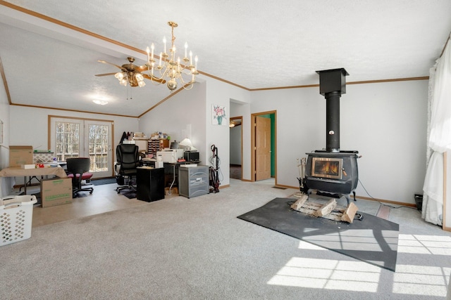 interior space with baseboards, carpet floors, a wood stove, ceiling fan, and crown molding