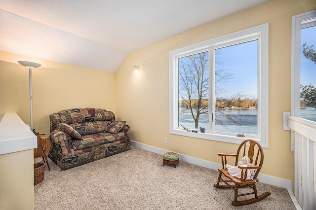 living area featuring baseboards, lofted ceiling, and carpet