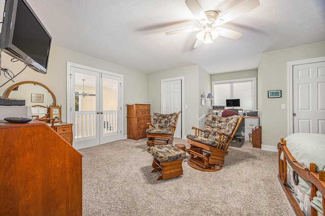 bedroom featuring access to exterior, french doors, a textured ceiling, and carpet floors