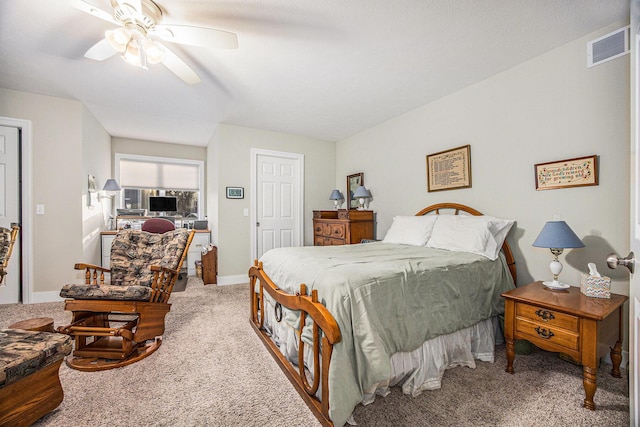 carpeted bedroom featuring visible vents, ceiling fan, and baseboards