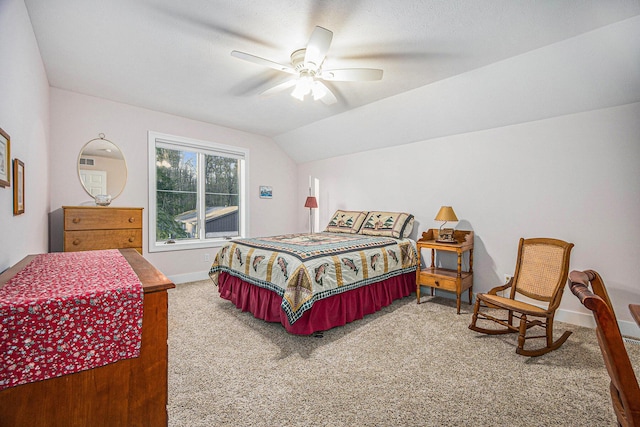 carpeted bedroom featuring a textured ceiling, a ceiling fan, baseboards, and vaulted ceiling