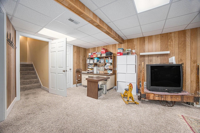 interior space featuring visible vents, wood walls, stairs, carpet flooring, and a paneled ceiling