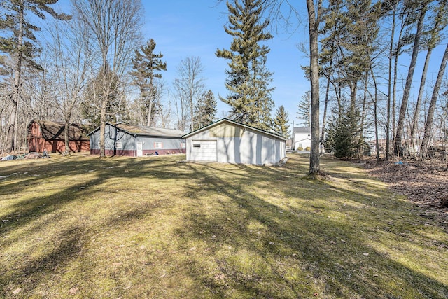 view of yard with an outbuilding and a detached garage