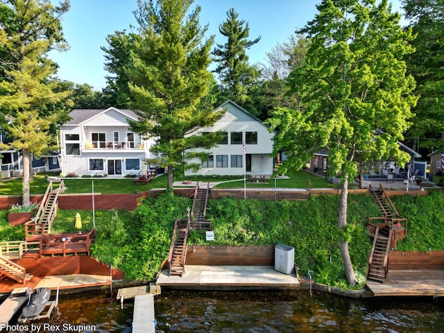 5569 Front St, Newaygo, MI 49337 - back of property with stairway, a yard, and a deck with water view