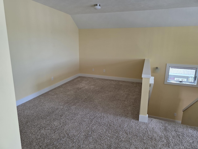 5569 Front St, Newaygo, MI 49337 - carpeted empty room featuring lofted ceiling and baseboards