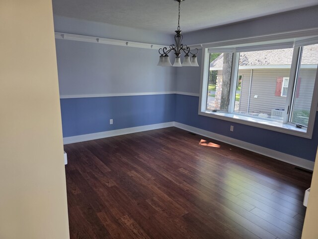 5569 Front St, Newaygo, MI 49337 - empty room with a chandelier and dark wood-style floors