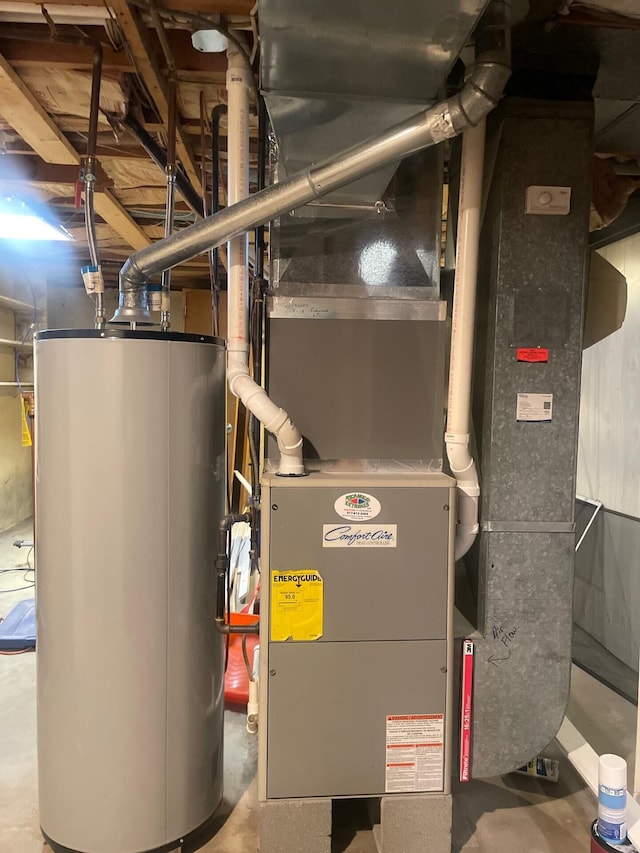 utility room featuring gas water heater and heating unit