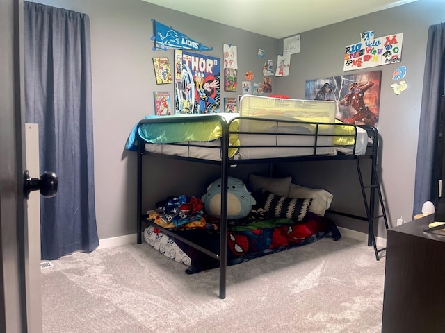 carpeted bedroom featuring baseboards