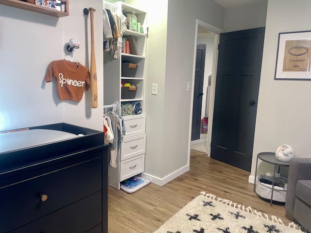 interior space featuring baseboards and light wood-style flooring