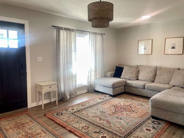 living room featuring wood finished floors and baseboards