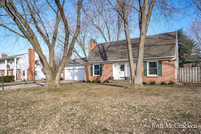 view of front of property featuring brick siding, an attached garage, a chimney, and fence