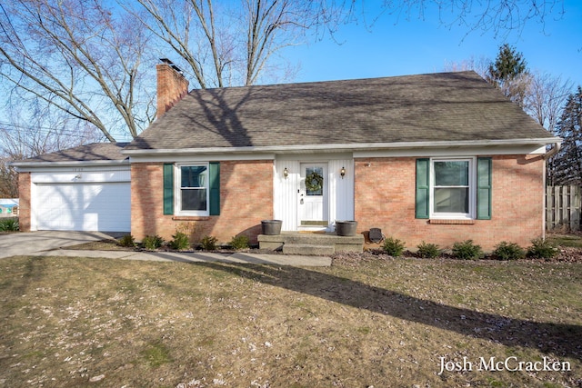 view of front facade with brick siding, an attached garage, concrete driveway, and a chimney