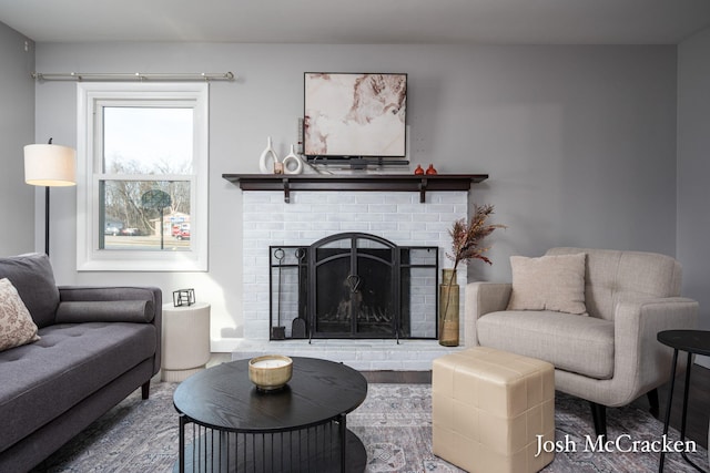 living area with a fireplace and wood finished floors