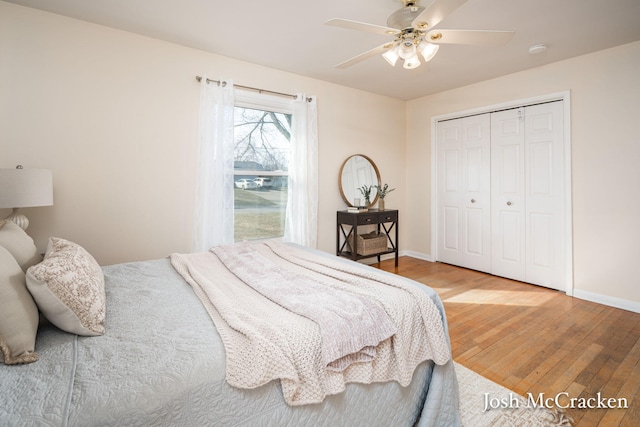 bedroom featuring a closet, baseboards, light wood-style flooring, and a ceiling fan