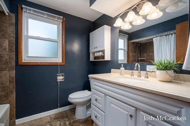 bathroom with toilet, a shower with curtain, vanity, and baseboards