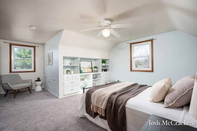 bedroom featuring baseboards, lofted ceiling, light colored carpet, and a ceiling fan