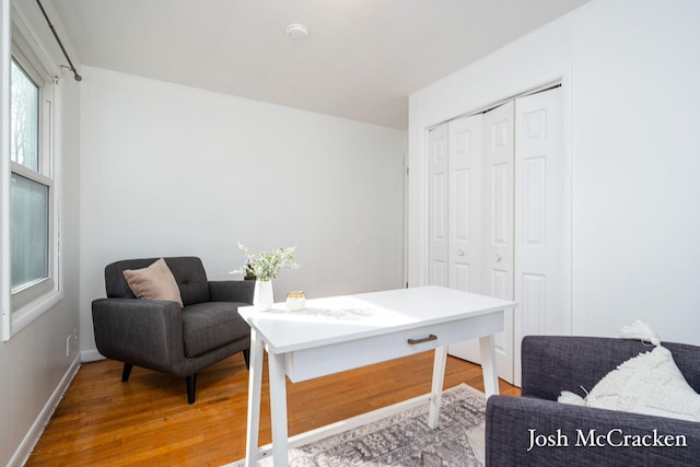 living area with wood finished floors and baseboards