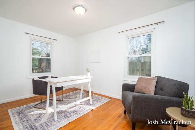 home office with baseboards and light wood finished floors