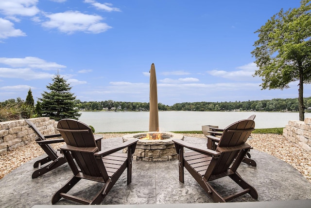 view of patio / terrace featuring a water view and an outdoor fire pit