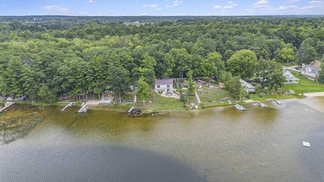 birds eye view of property with a forest view and a water view