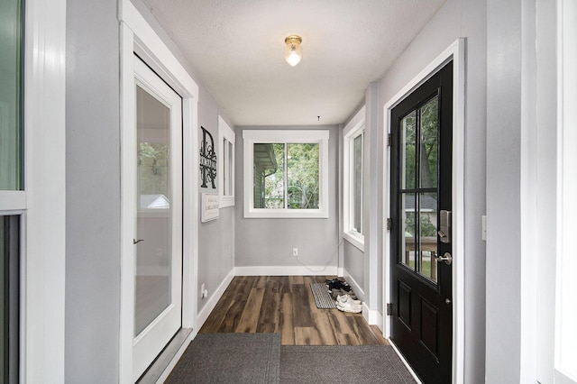 interior space featuring dark wood-type flooring and baseboards