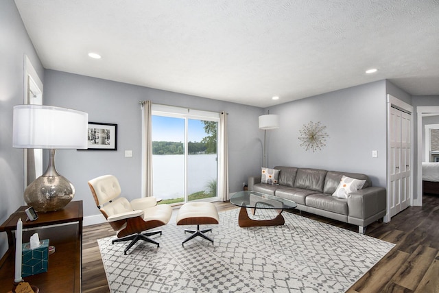 living room with recessed lighting, baseboards, and dark wood-style floors