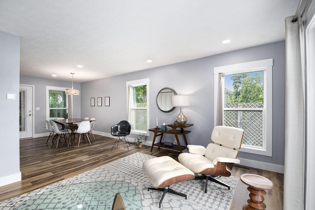 living area featuring recessed lighting, wood finished floors, and baseboards