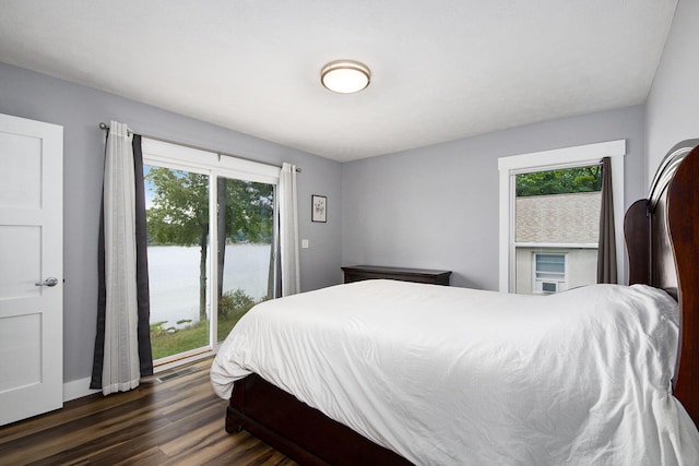 bedroom featuring dark wood finished floors, visible vents, and multiple windows