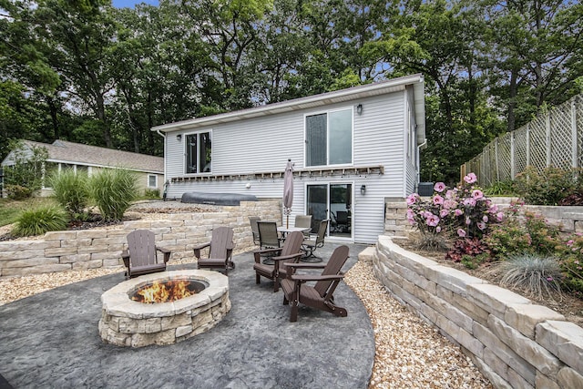 back of house with a patio, a fire pit, and fence